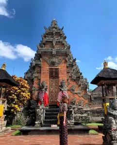 Balinese temple with woman standing in front